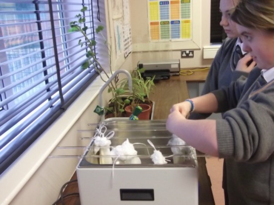 Hanging to drain excess whey